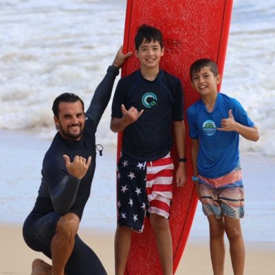Davis Cleveland et al. standing on top of a sandy beach