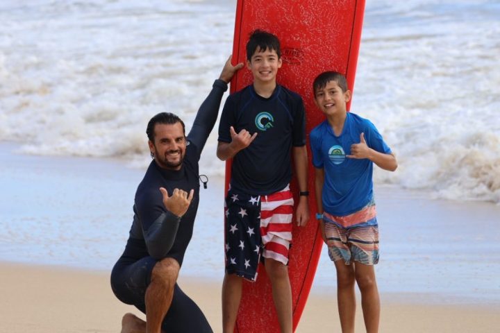 Davis Cleveland et al. standing on top of a sandy beach