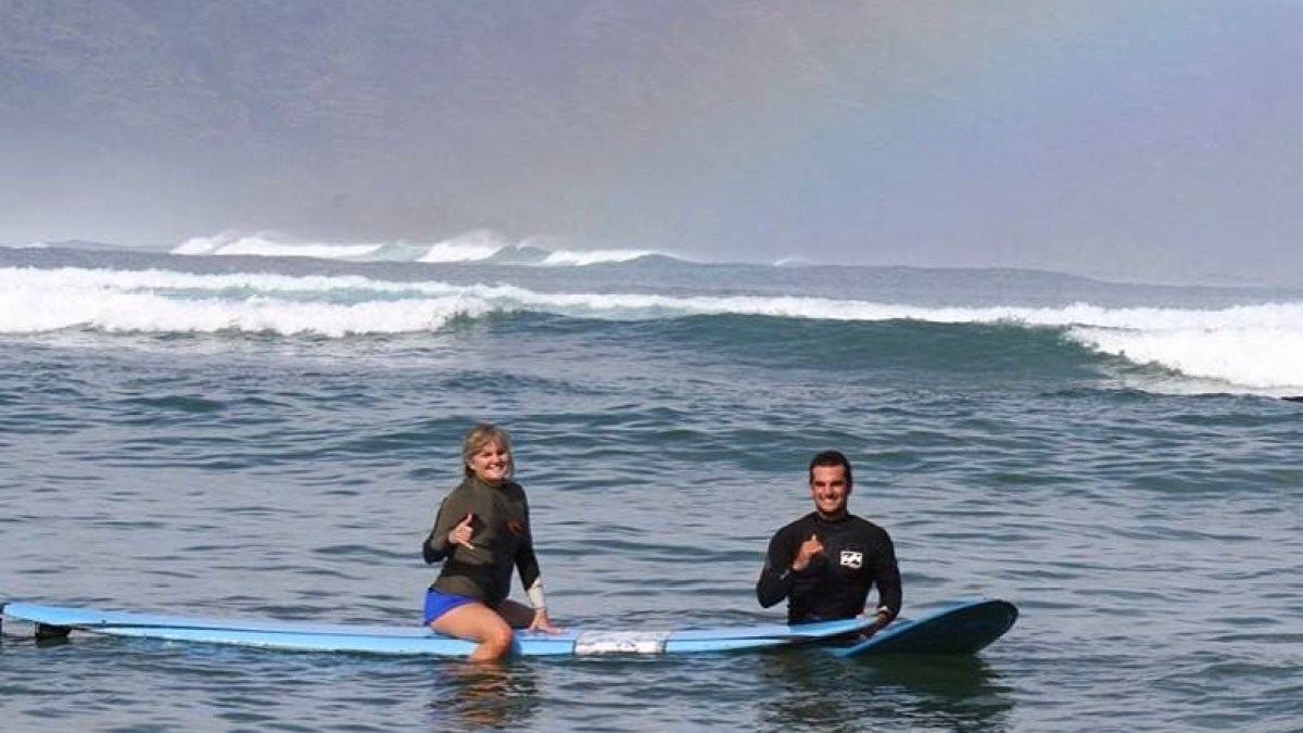 a man riding a wave on a surfboard in the water