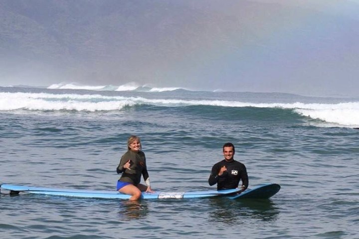a man riding a wave on a surfboard in the water