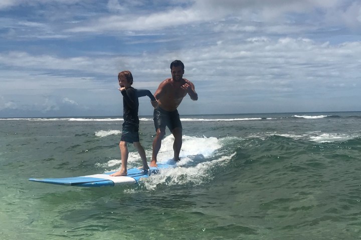 a man riding a wave on a surfboard in the ocean