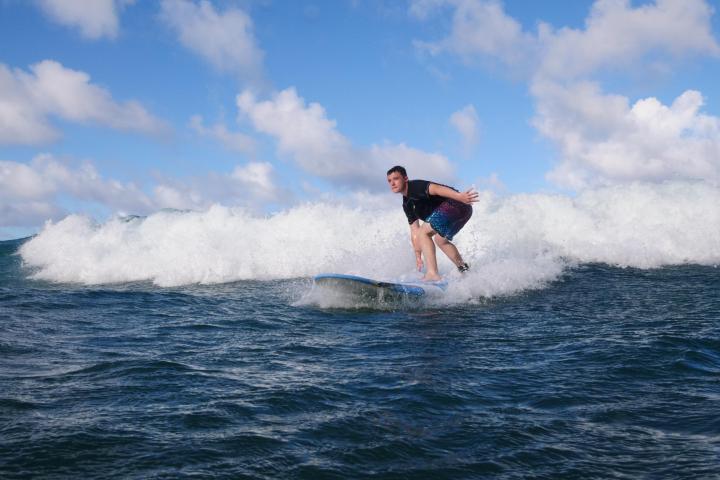 a man riding a wave on a surfboard in the ocean