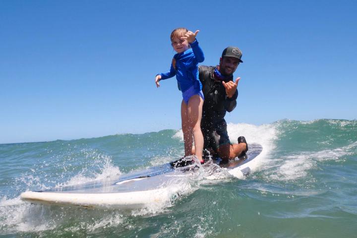 a man riding a wave on a surfboard in the water