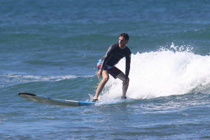 a man riding a wave on a surfboard in the ocean