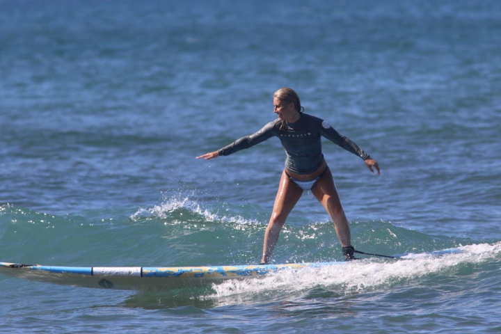 a young man riding a wave on a surfboard in the ocean