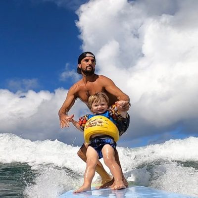 a man riding a wave on a surfboard in the water