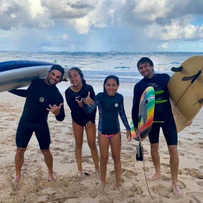 a group of people standing on top of a sandy beach